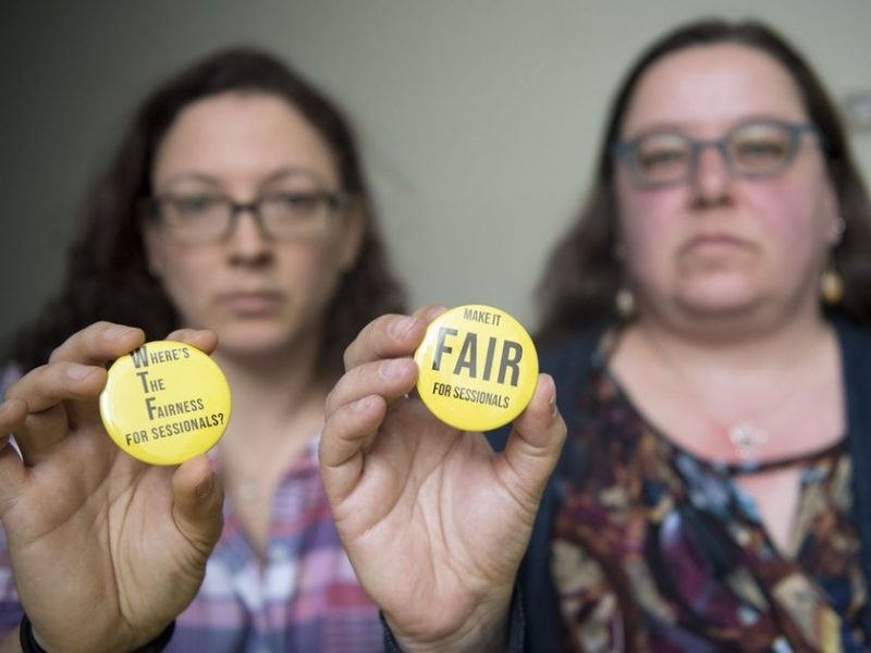 Photo of URFA members holding Make It Fair For Sessionals buttons.