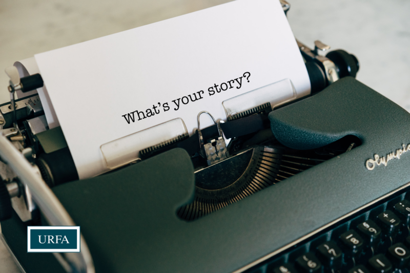 A green typewriter with a sheet of paper that says "What's your story?" URFA logo bottom left.